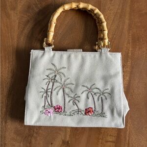 Canvas tote bag with embroidered tropical palm trees and bamboo handles